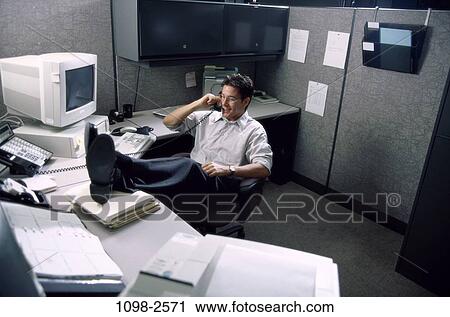 relaxed, desk, telephone, talking, paperwork, eyeglasses View Large Photo Image Stock Image - relaxed, desk, telephone, talking, paperwork, eyeglasses. Fotosearch