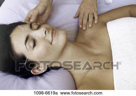 Stock Image - relaxed, people, woman, calm, patient, acupuncture, health. Fotosearch