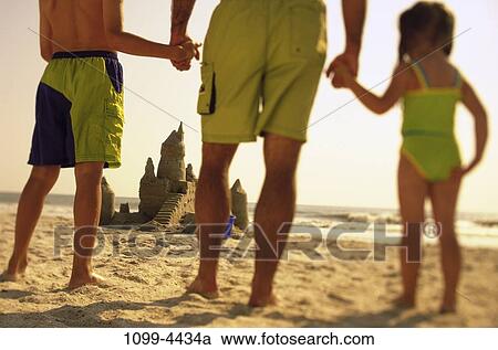 sand, people, hands, water, building, playing, sea View Large Photo Image Stock Image - sand, people, hands, water, building, playing, sea. Fotosearch