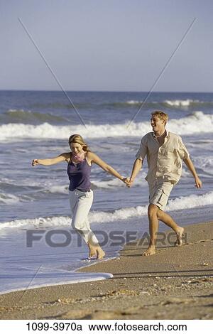 sand, people, water, running, walking, couple, beach View Large Photo Image Stock Image - sand, people, water, running, walking, couple, beach. Fotosearch