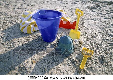 sand, shadows, beach, shovel, equipment, objects, shore View Large Photo Image Stock Image - sand, shadows, beach, shovel, equipment, objects, shore. Fotosearch