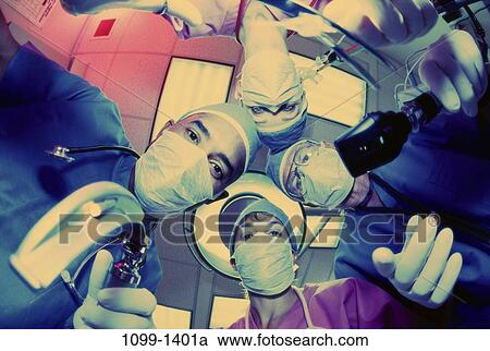 Stock Image - scrubs, surgery, tools, reaching, personnel, gear, hospital. Fotosearch
