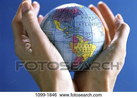 Stock Photograph - small, hands, globe, holding, contrast, nurturing, South America. Fotosearch