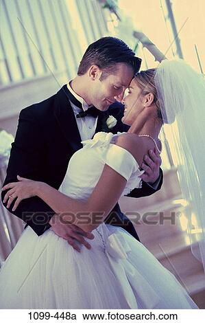 Stock Image - stair, outdoors, joyous, beginnings, embracing, wedding, tuxedo. Fotosearch