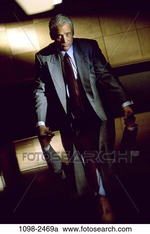 Stock Image - table, leader, business, leadership, Middle-aged, serious. Fotosearch