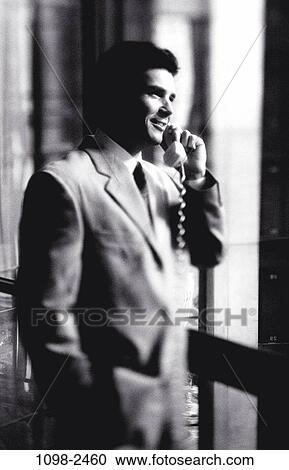 Stock Image - telephone, talking, window, phone, business, Middle-aged. Fotosearch