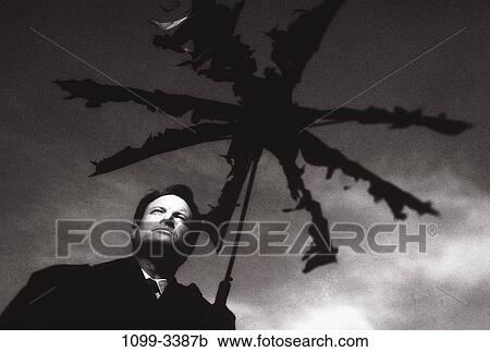 Stock Image - umbrella, business, weather, Middle-aged, businessman, metaphor. Fotosearch
