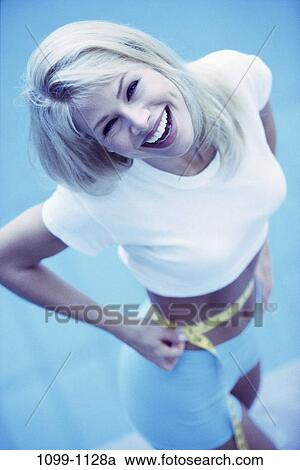 Stock Image - white, woman, smiling, tape, diet, shorts, measurement. Fotosearch