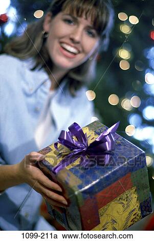 Stock Image - woman, Christmas, holidays, gift, present, Caucasian, Decorations Christmas. Fotosearch