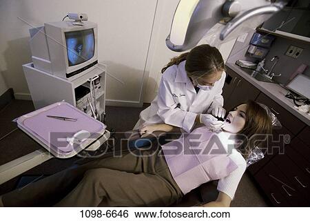 Stock Photograph - women, monitor, patient, dentist, doctor, equipment, tools. Fotosearch