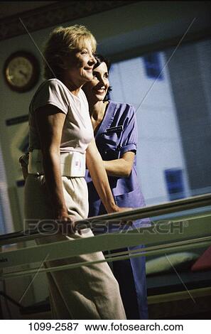 Stock Photo - women, walking, patient, physical, health, rails, trying. Fotosearch