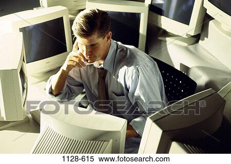 Stock Photography - desk, stress, contemplation, computers, serious, contemplating. Fotosearch
