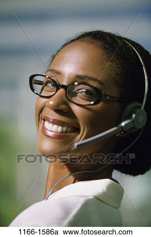 desk, woman, headset, eyeglasses, phone, business, headphone View Large Photo Image Stock Image - desk, woman, headset, eyeglasses, phone, business, headphone. Fotosearch