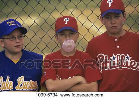 Picture - fence, people, playing, baseball, leaning, bubble, standing. Fotosearch