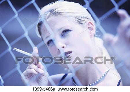 fence, people, smoke, cigarette, holding, blond, smoking View Large Photo Image Stock Image - fence, people, smoke, cigarette, holding, blond, smoking. Fotosearch