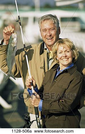 Stock Image - fish, people, success, couple, catching, outdoors, Middle-aged. Fotosearch