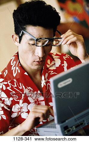 frowning, eyeglasses, concentrating, typing, sitting, Asian View Large Photo Image Stock Image - frowning, eyeglasses, concentrating, typing, sitting, Asian. Fotosearch