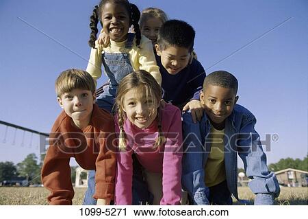 grass, multiethnic, people, balance, smiling, playing, playground View Large Photo Image Stock Image - grass, multiethnic, people, balance, smiling, playing, playground. Fotosearch