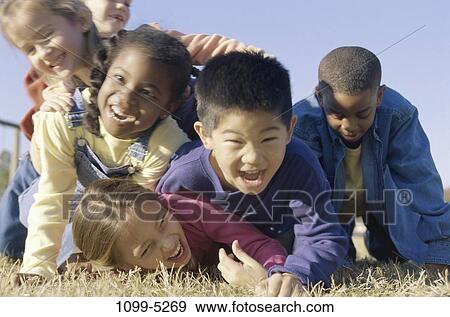 grass, multiethnic, people, playing, ground, laughing, playful View Large Photo Image Stock Photo - grass, multiethnic, people, playing, ground, laughing, playful. Fotosearch