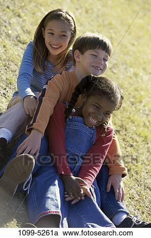 grass, multiethnic, people, smiling, playing, ground, sitting View Large Photo Image Stock Image - grass, multiethnic, people, smiling, playing, ground, sitting. Fotosearch