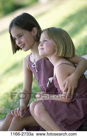 grass, people, sitting, holding, outdoors, hugging, friends View Large Photo Image Stock Image - grass, people, sitting, holding, outdoors, hugging, friends. Fotosearch