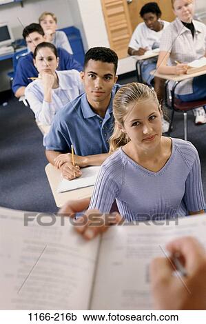 Stock Image - group, multiethnic, people, listening, school, classroom, book. Fotosearch