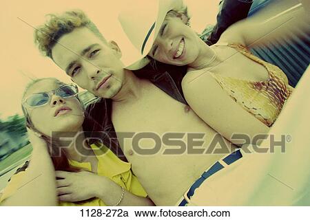 Stock Image - groups, people, smiling, car, sunglasses, outdoors, relaxing. Fotosearch
