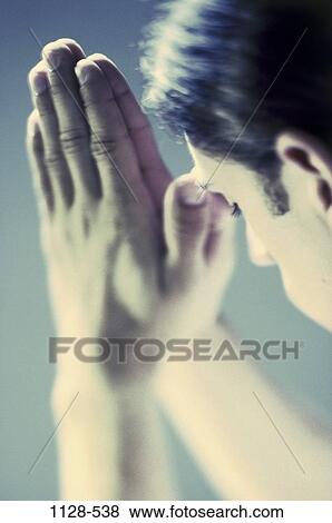 Stock Photo - hands, religious, religion, pray, prayer, brunette. Fotosearch