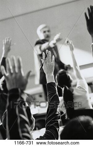 Stock Image - hands, teacher, school, raised, enthusiastic, classroom, education. Fotosearch
