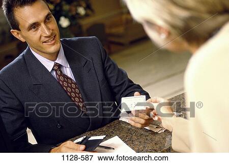 hotel, smiling, newspaper, business, smile, wallet, credit card View Large Photo Image Stock Photo - hotel, smiling, newspaper, business, smile, wallet, credit card. Fotosearch