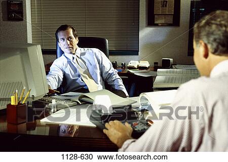 Stock Image - meeting, desk, talking, discussion, computer, business, businessmen. Fotosearch