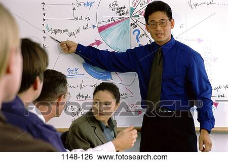 Stock Photograph - meeting, group, multiethnic, presentation, chart, pointing. Fotosearch