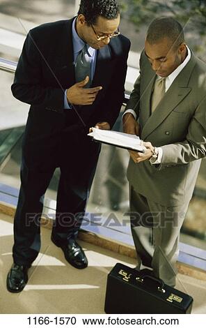 men, briefcase, talking, paperwork, eyeglasses, conversation, reading View Large Photo Image Stock Image - men, briefcase, talking, paperwork, eyeglasses, conversation, reading. Fotosearch