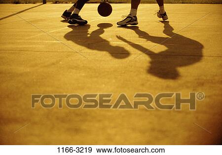Stock Photo - men, shadows, playing, ball, challenges, court, teamwork. Fotosearch
