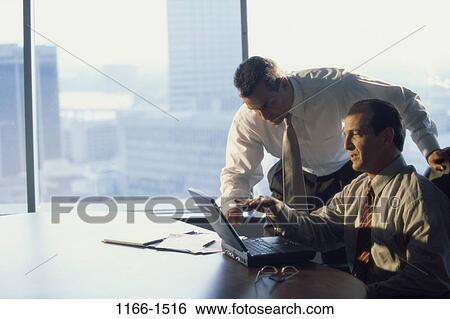 Stock Photograph - men, table, coworkers, computer, laptop, leaning, business. Fotosearch