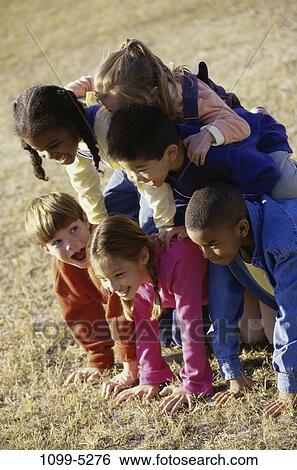 multiethnic, people, balance, playing, laughing, stacked, outdoors View Large Photo Image Stock Photograph - multiethnic, people, balance, playing, laughing, stacked, outdoors. Fotosearch