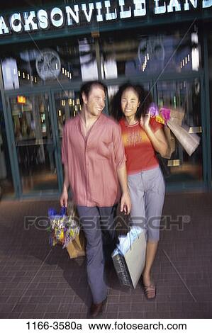 Stock Image - multiethnic, people, blur, couple, outdoors, shopping, shop. Fotosearch