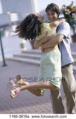multiethnic, people, couple, flowers, outdoors, hugging, hug View Large Photo Image Stock Image - multiethnic, people, couple, flowers, outdoors, hugging, hug. Fotosearch