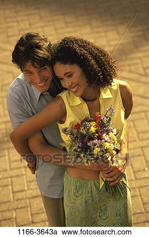 multiethnic, people, couple, flowers, outdoors, hugging, hug View Large Photo Image Stock Image - multiethnic, people, couple, flowers, outdoors, hugging, hug. Fotosearch