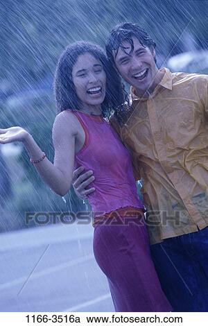 multiethnic, people, couple, rain, laughing, standing, outdoors View Large Photo Image Stock Image - multiethnic, people, couple, rain, laughing, standing, outdoors. Fotosearch