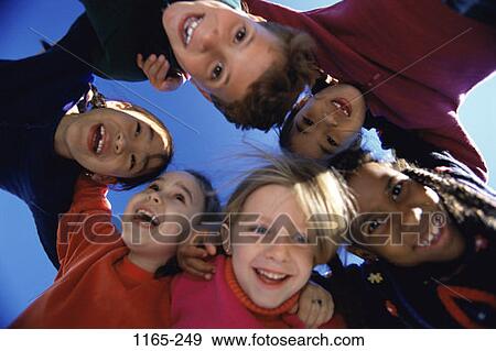 Stock Photo - multiethnic, people, playing, outdoors, hugging, friends, diversity. Fotosearch