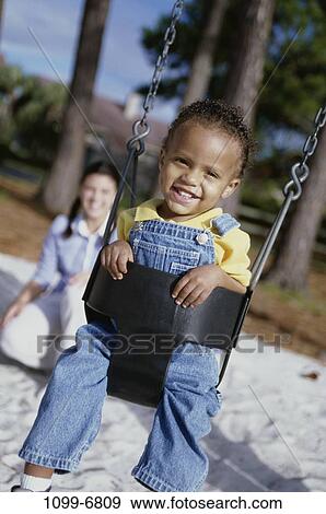 multiethnic, people, playing, swinging, swing, playground, outdoors View Large Photo Image Stock Photo - multiethnic, people, playing, swinging, swing, playground, outdoors. Fotosearch