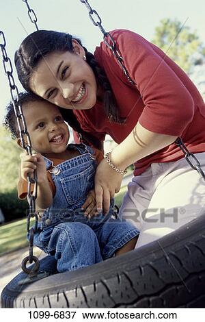 multiethnic, people, playing, swinging, swing, playground, outdoors View Large Photo Image Stock Photo - multiethnic, people, playing, swinging, swing, playground, outdoors. Fotosearch