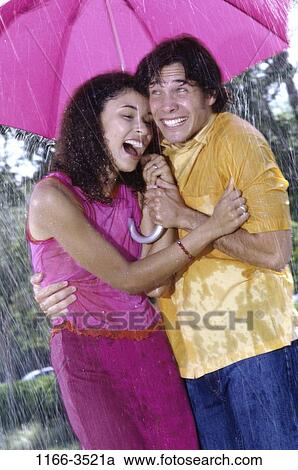 multiethnic, people, umbrella, couple, rain, standing, outdoors View Large Photo Image Stock Image - multiethnic, people, umbrella, couple, rain, standing, outdoors. Fotosearch