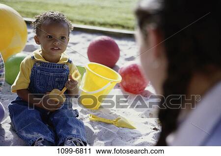 multiethnic, sand, people, playing, listening, sitting, balls View Large Photo Image Stock Image - multiethnic, sand, people, playing, listening, sitting, balls. Fotosearch