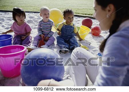 multiethnic, sand, people, playing, balls, playground, outdoors View Large Photo Image Stock Image - multiethnic, sand, people, playing, balls, playground, outdoors. Fotosearch