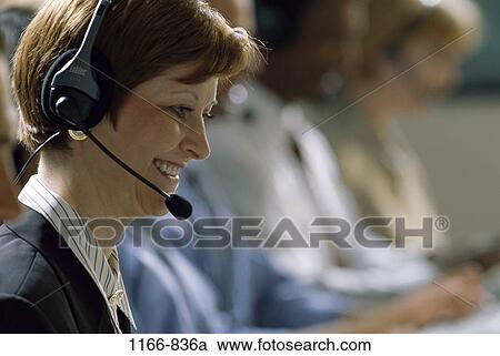 Stock Image - multiethnic, woman, headset, smiling, telephone, phone, business. Fotosearch