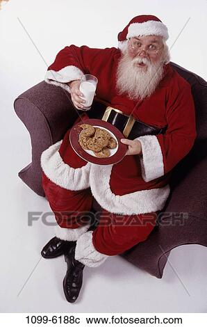 Stock Image - overhead, eating, sitting, milk, Christmas, traditional, surprise. Fotosearch