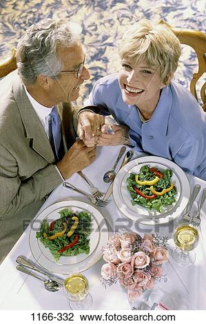 Stock Image - overhead, people, hands, table, couple, senior, wine. Fotosearch