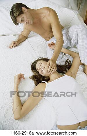 Stock Image - overhead, people, relaxation, couple, bed, relaxing, resting. Fotosearch